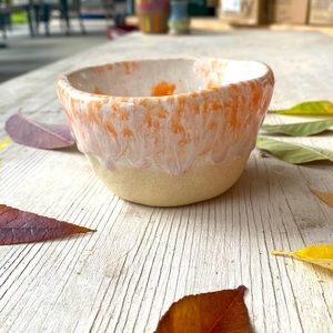 Small orange and white stoneware pot